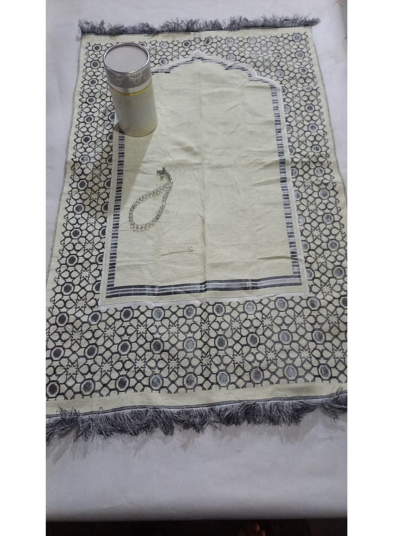 A box containing a prayer mat and prayer beads